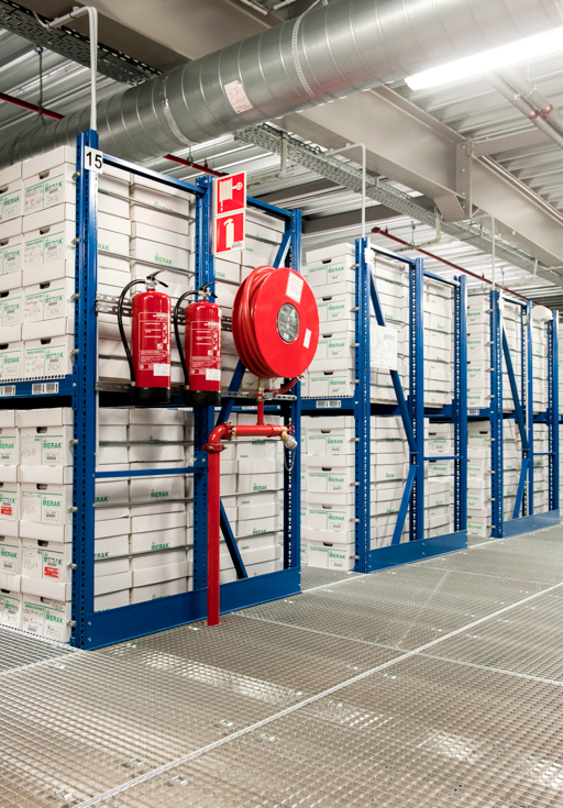 Racks filled with archive boxes with fire extinguishing material on the side