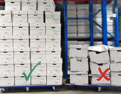 A stack of archive boxes in good condition next to a stack of archive boxes in very poor condition