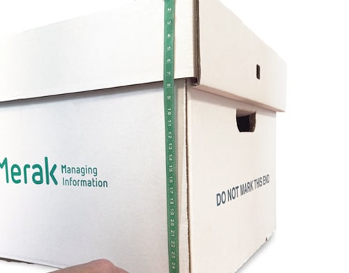 Green tape measure held against the side of an archive box
