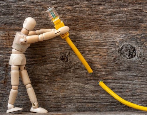 Wooden puppet pulling down a yellow cable