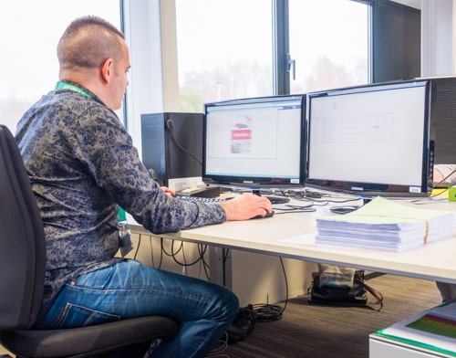 An employee of Merak is working on the computer