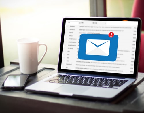 A laptop with the icon of e-mail on the screen