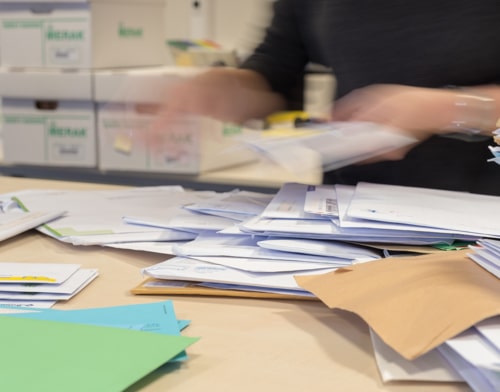 An employee is busy sorting mail