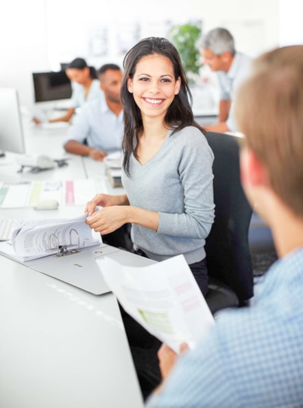 Working people at their desks have a pleasant collaboration